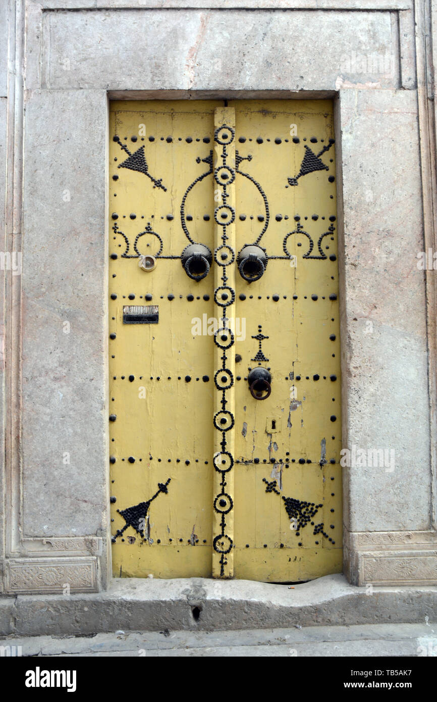 The traditional studded door of a 17th century house in an alleyway of the medina (old city) of Tunis, Tunisia. Stock Photo