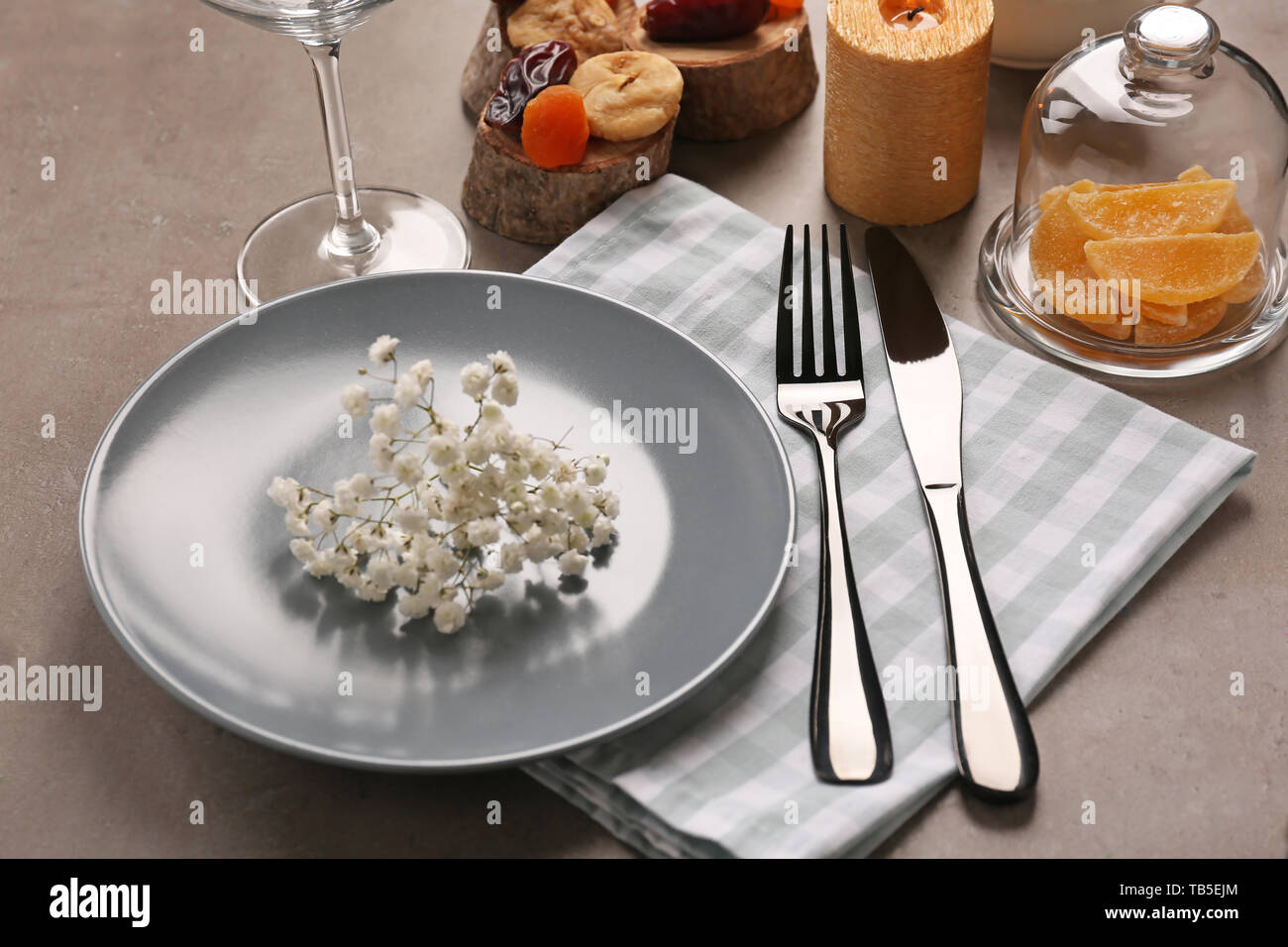 Beautiful table setting on grey background Stock Photo