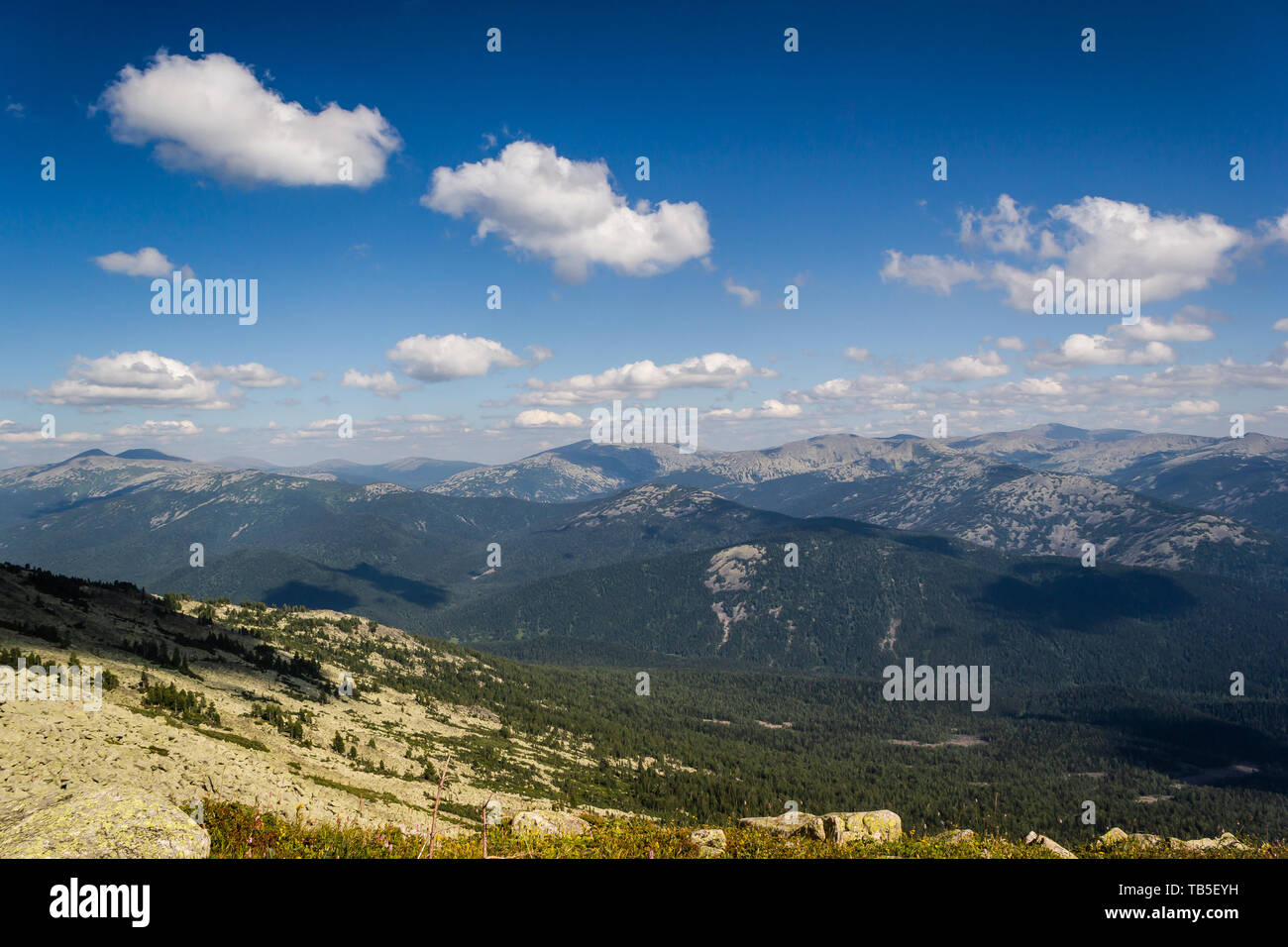Rocks under blue sky with clouds. View of mountain valley. Tourism ...