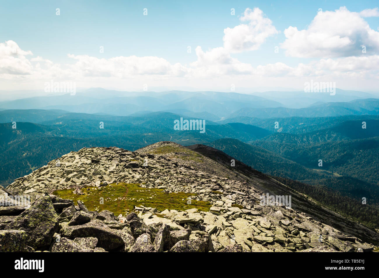 Rocks under blue sky with clouds. View of mountain valley. Tourism ...