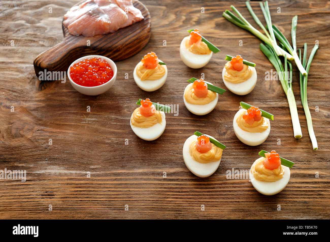 Tasty deviled eggs on wooden table Stock Photo