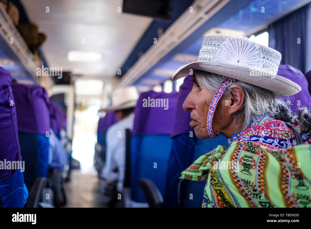 Elderly local woman sitting on the bus and wearing a fancy traditional hat in Chivay, Arequipa Region, Peru Stock Photo