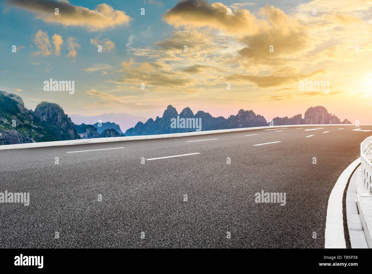 Asphalt highway road and beautiful huangshan mountains nature landscape at sunrise Stock Photo