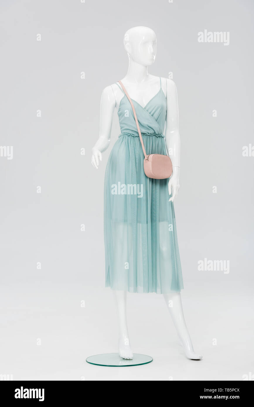 https://c8.alamy.com/comp/TB5PCX/plastic-mannequin-with-bag-and-dress-isolated-on-grey-TB5PCX.jpg