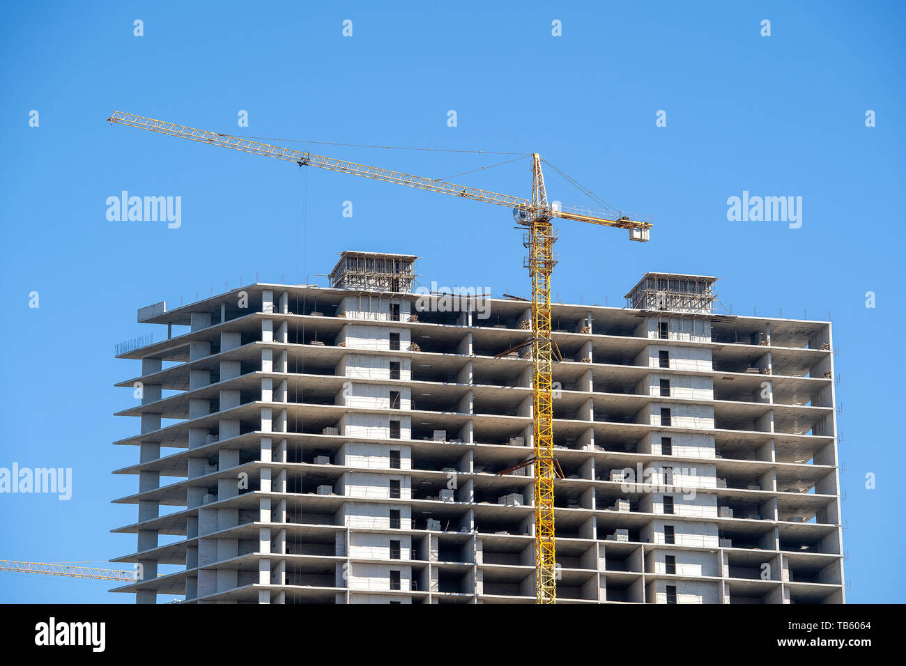 Construction of a highrise building with a crane. Building