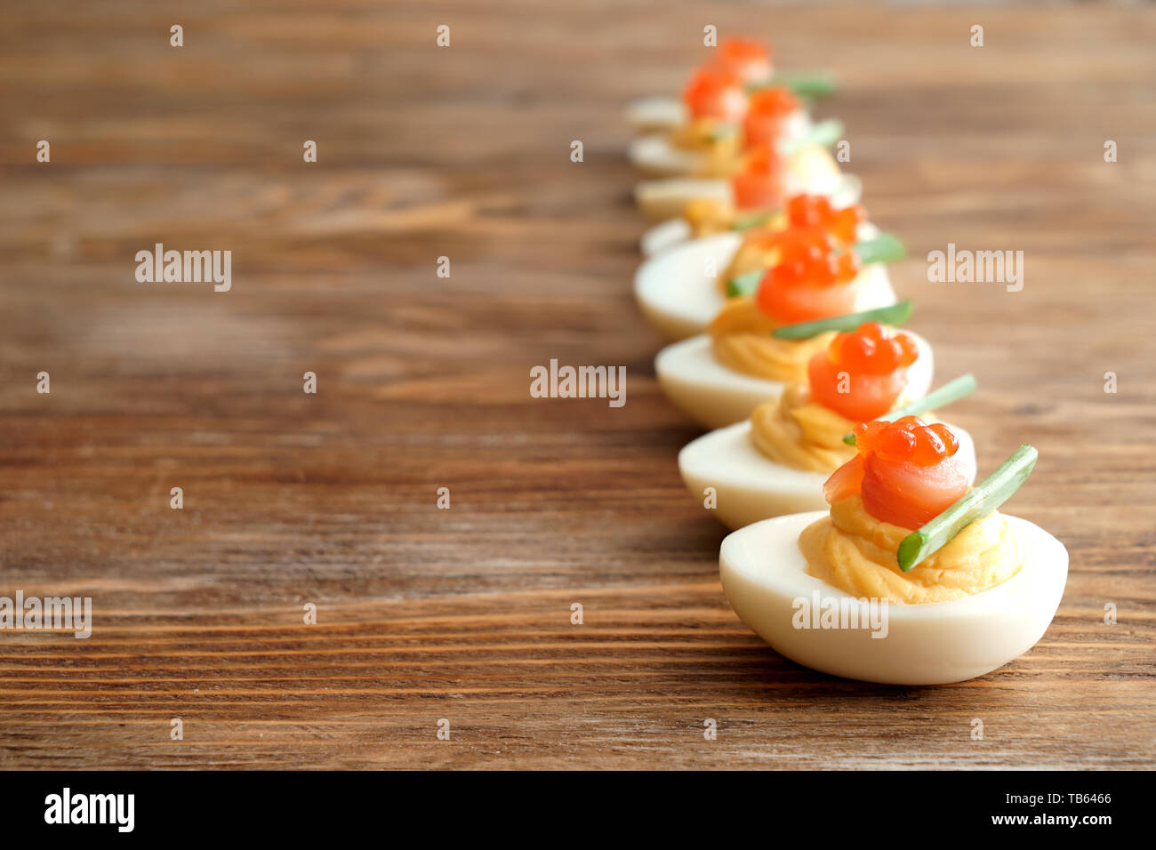 Tasty deviled eggs on wooden table Stock Photo