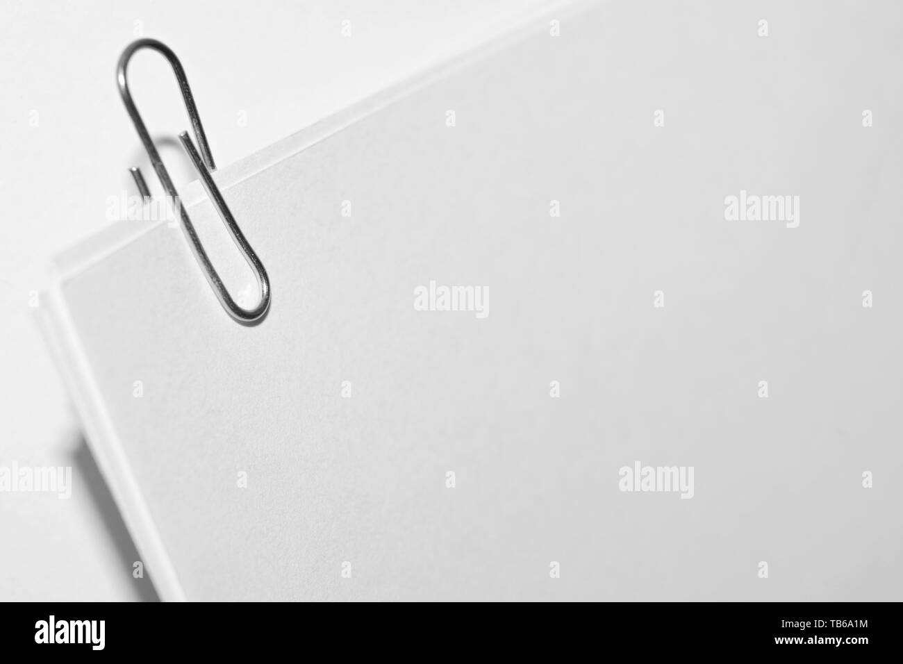 paper clip on white paper sheets close up Stock Photo Alamy