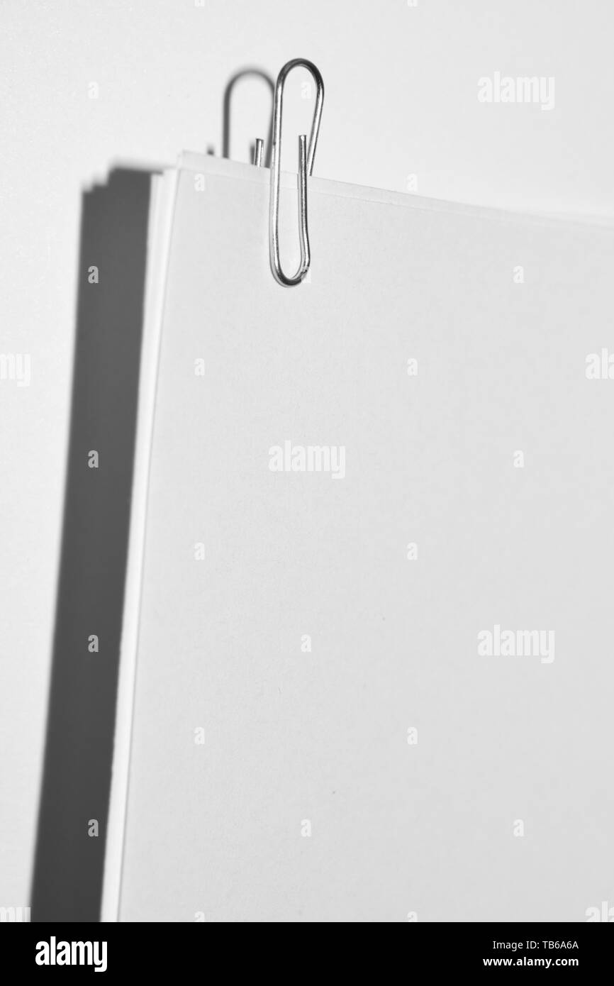 paper clip on white paper sheets close up Stock Photo Alamy