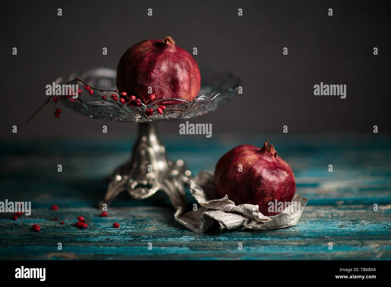 Still Life with Pomegranate on antique glass bowl Stock Photo