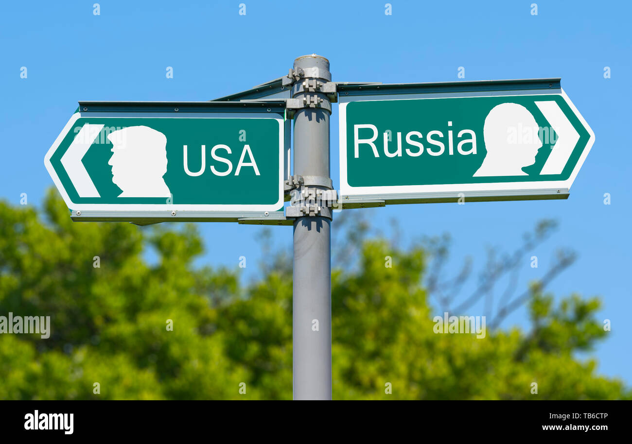 USA or Russia direction sign with depictions of USA President Donald Trump and Russian President Vladimir Putin on the sign. America vs Russia. Stock Photo