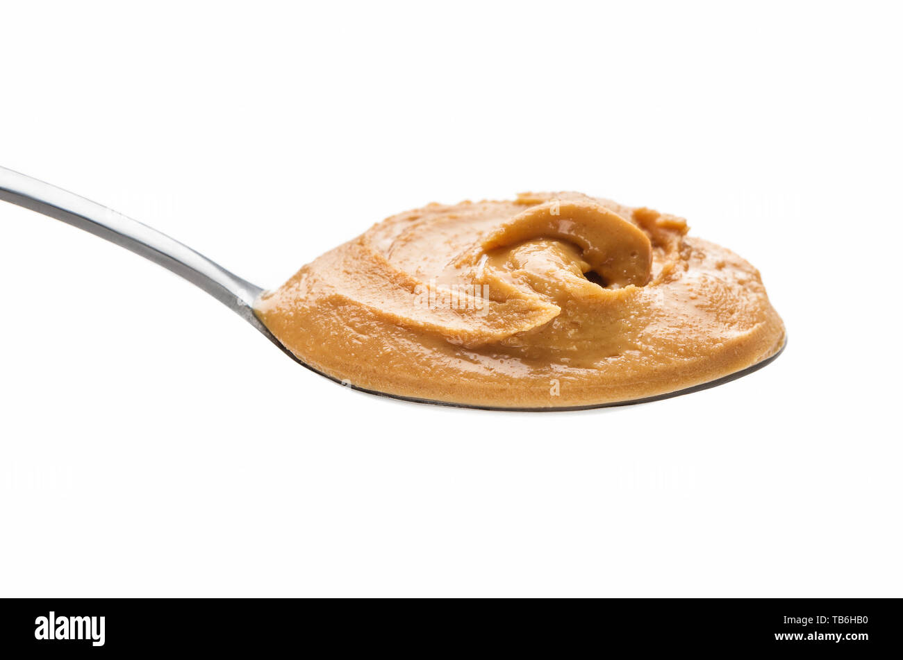Peanut spread in spoon isolated on white background Stock Photo