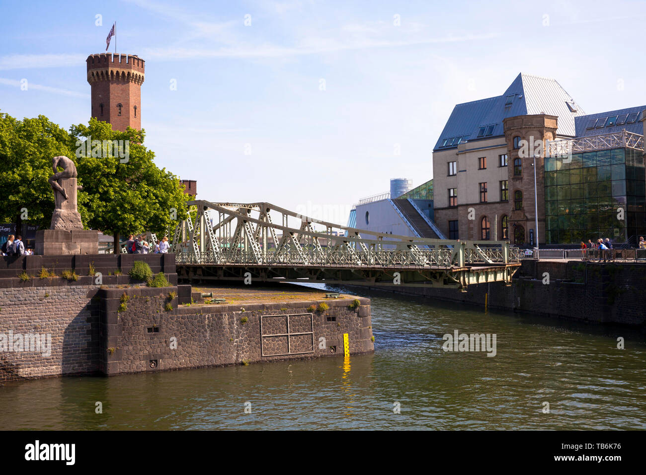 the open swing bridge at the Rheinau harbor, the Malakoff tower and the Chocolate Museum, Cologne, Germany.  die geoeffnete Drehbruecke am Rheinauhafe Stock Photo