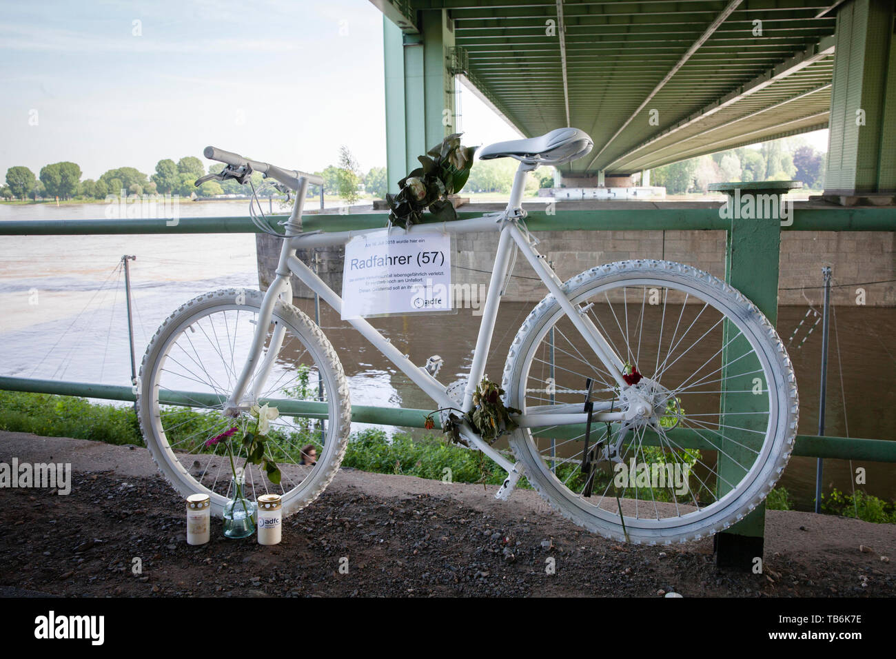 ghost bike under the Rodenkirchener bridge, white adorned bicycle reminds of a cyclist, who had a deadly accident at this place, Cologne, Germany.  Ge Stock Photo