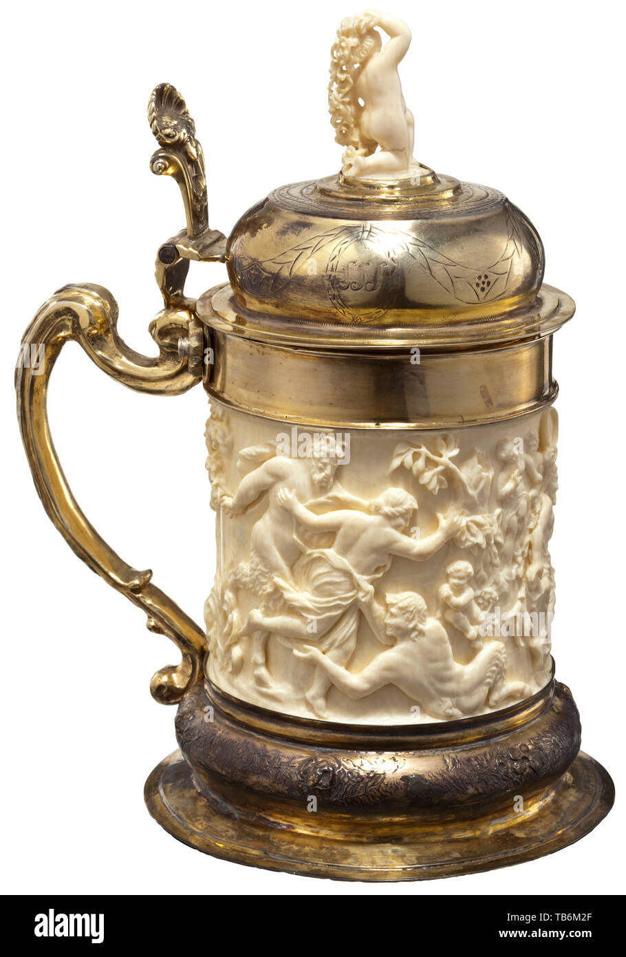 A German vermeil-mounted ivory tankard, circa 1860, Elaborately crafted tankard in baroque style. Body made of ivory with continuous multi-figured Bacchanalian scene in half relief. Depiction of a recumbent Dionysius surrounded by satyrs and bacchantes. Mounting of fire-gilt silver, the foot with engraved and partly chased flower ornaments. Screw-mounted volute handle, shell-shaped thumb piece with mascaron. Hinged domed lid decorated with engraved garlands and monogram cartouche 'MCS'. The top of the lid is crowned with a kneeling ivory putto wi, Additional-Rights-Clearance-Info-Not-Available Stock Photo