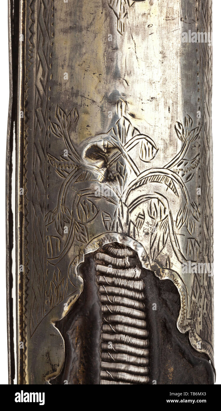 An Ottoman silver-mounted kilij, circa 1800, Curved single-edged blade of Sham Damascus with a broad, double-edged point. The quillons with geometric engravings, the grip frame of silver with riveted horn grip panels and attached hand loop. The wooden scabbard covered with shagreen leather, decorated with elaborate cord underlays and broadly stitched with silver wire, with florally engraved silver mounts and blade slit cover, the suspension bars with stylised dragon heads in relief. The scabbard mounts each stamped with the tughra of Selim III (1, Additional-Rights-Clearance-Info-Not-Available Stock Photo