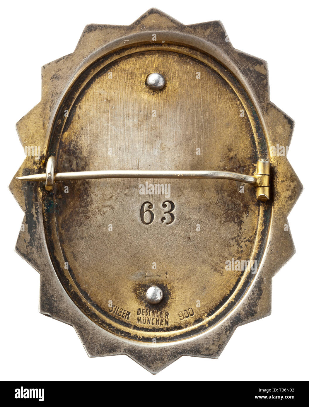 A badge of honour for members of the Reich Senate of Culture - badge with membership number '63', Vertical oval badge with 16-fold serrated border produced in silver, the oval with light ivory-coloured enamel and a depiction of the badge of the Reich Chamber for Culture (an eagle atop an ancient column) with the inscription 'REICHSKULTURSENAT'. The enamelled oval is double-riveted to the base plate, whose reverse bears the struck enrolment number '63' and maker's designation 'DESCHLER MÜNCHEN SILBER 900'. With a thin transverse attachment pin. Small usage-caused scratches. , Editorial-Use-Only Stock Photo