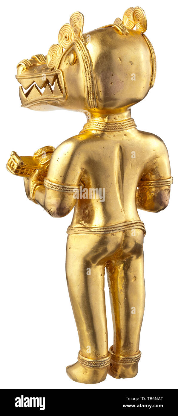 A Colombian tumbaga gold figure, Elaborately worked, hollow cast figure of gold/copper alloy. Portrayal of a deity with a crocodile head, holding in his hands a small crocodile. Height 15 cm, weight 205 g. Tumbaga alloy with its central components of gold and copper was prevalent in ancient Colombia and the neighbouring Central America. The copper contents can exceed more than 70%. During the manufacturing process the copper at the surface was dissolved through plant acids, creating a surface of pure gold. historic, historical pre-columbian, Additional-Rights-Clearance-Info-Not-Available Stock Photo
