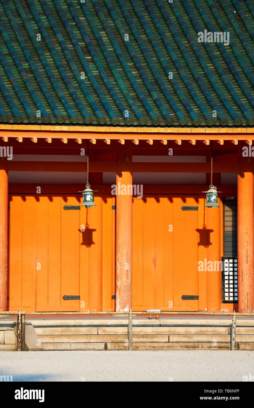 Traditional lanterns hang and cast shadows on the wall of the veranda around segment of wall at Heian Jingu Shrine in Kyoto, Japan. Stock Photo