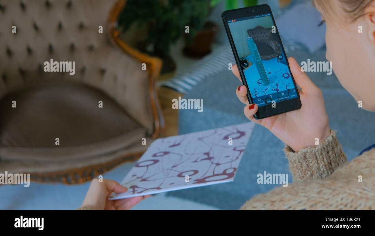 Woman using smartphone with augmented reality app Stock Photo