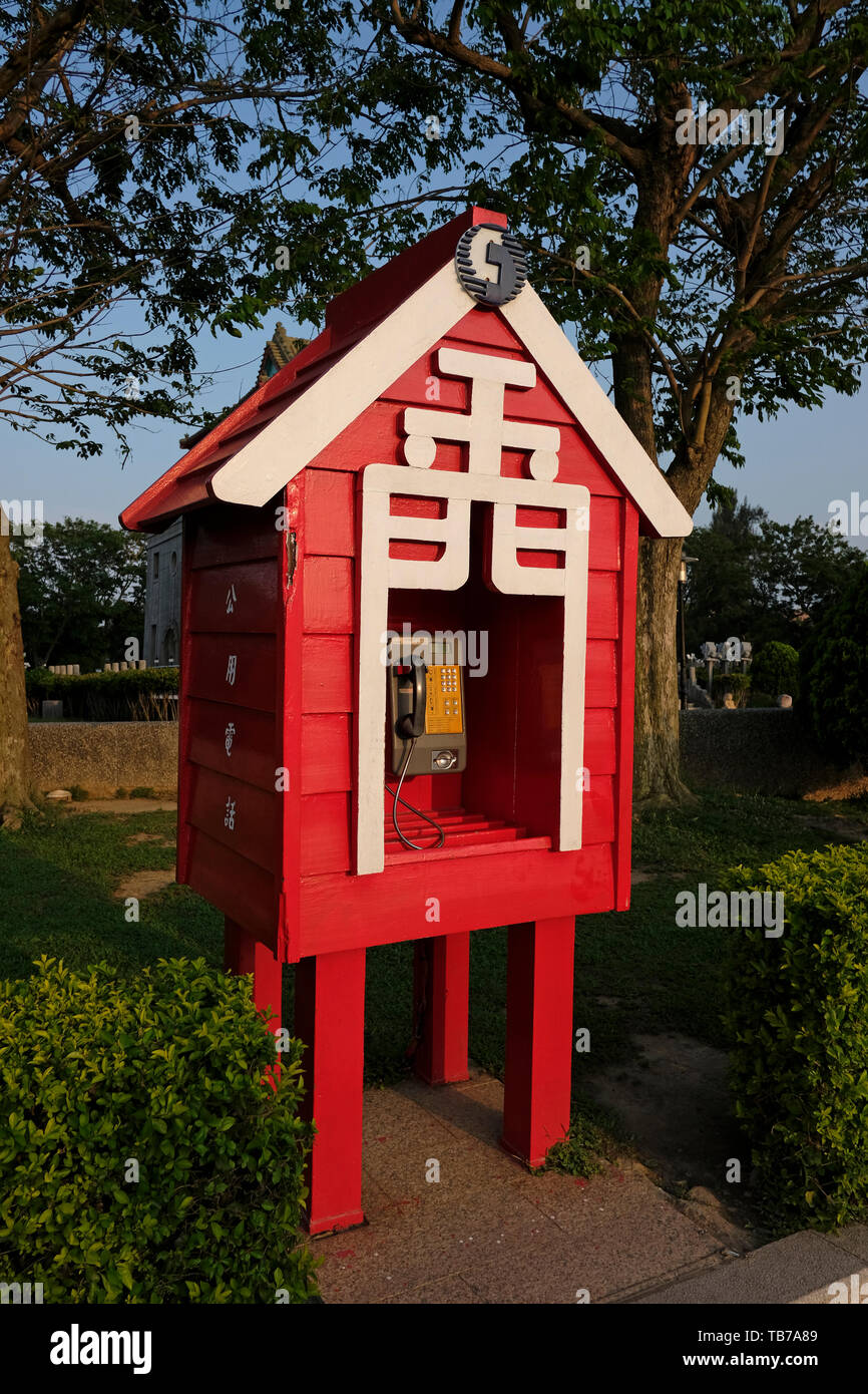 Red phone booth with the word Jīnmen or Golden Gate which means Kinmen in front of Ju Guang Lou in Jincheng Township, Kinmen County or island, Taiwan Stock Photo