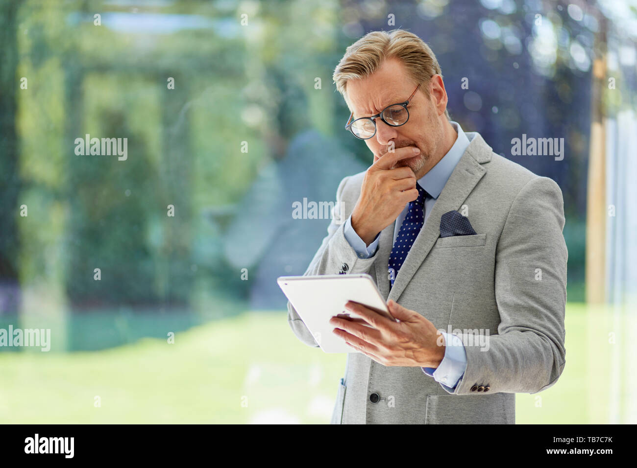 Businessman holding iPad Stock Photo