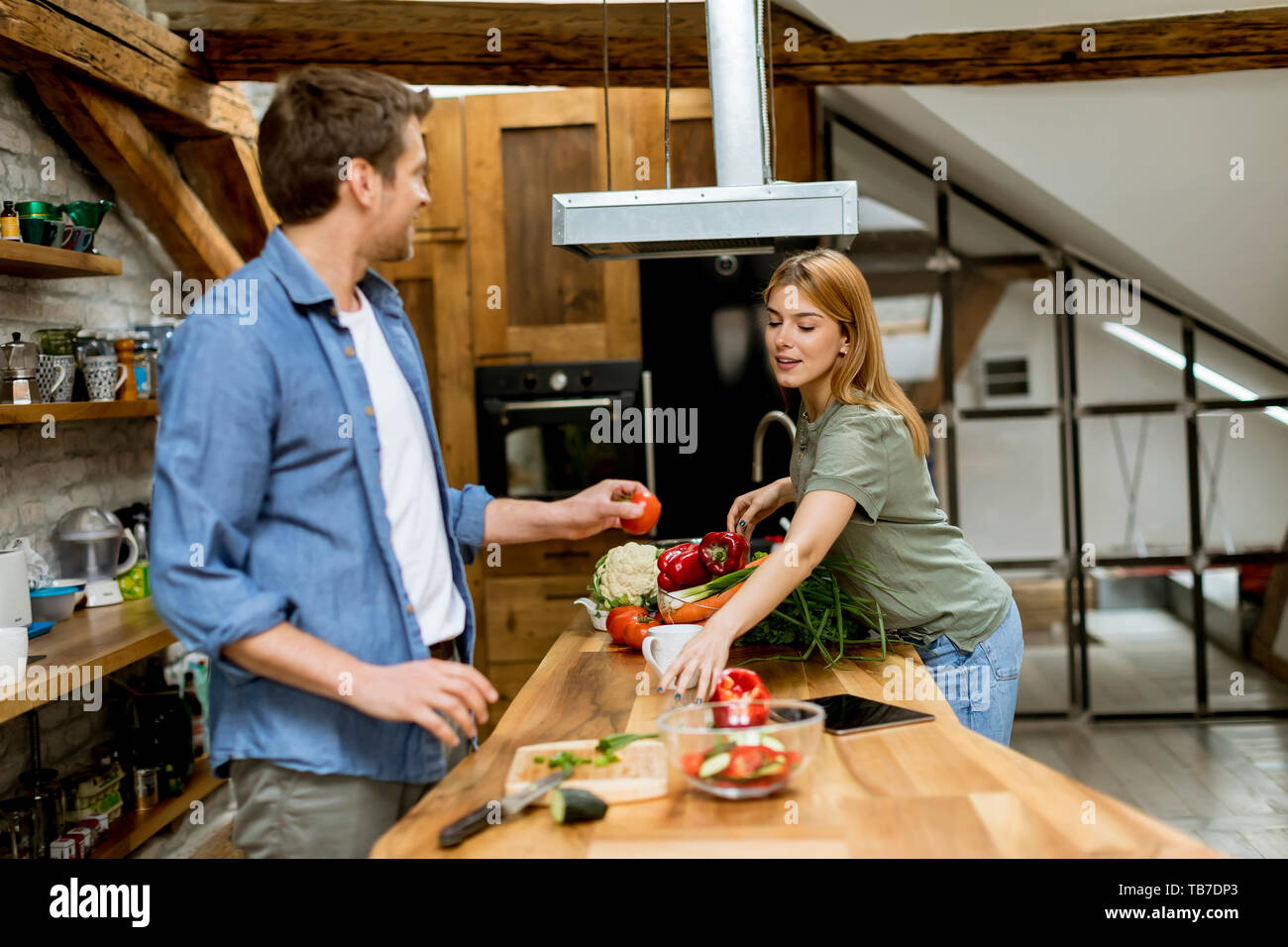 Lovely couple preparing food  in the kitchen Stock Photo