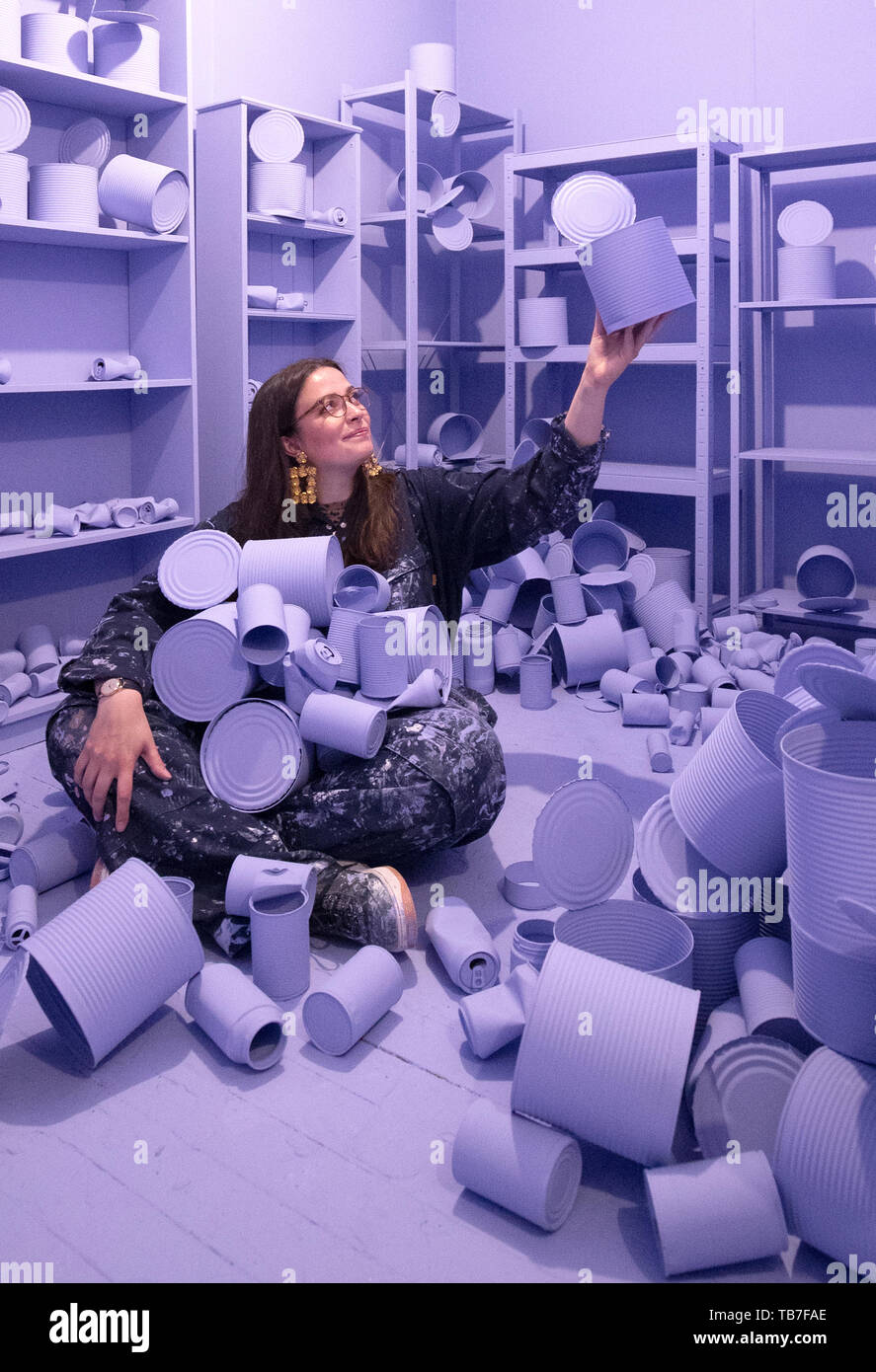 Sculpture student Gabrielle Gillott is surrounded by her bunker installation titled Safe Haven at the media preview of the Edinburgh College of Art degree show in Edinburgh. Stock Photo
