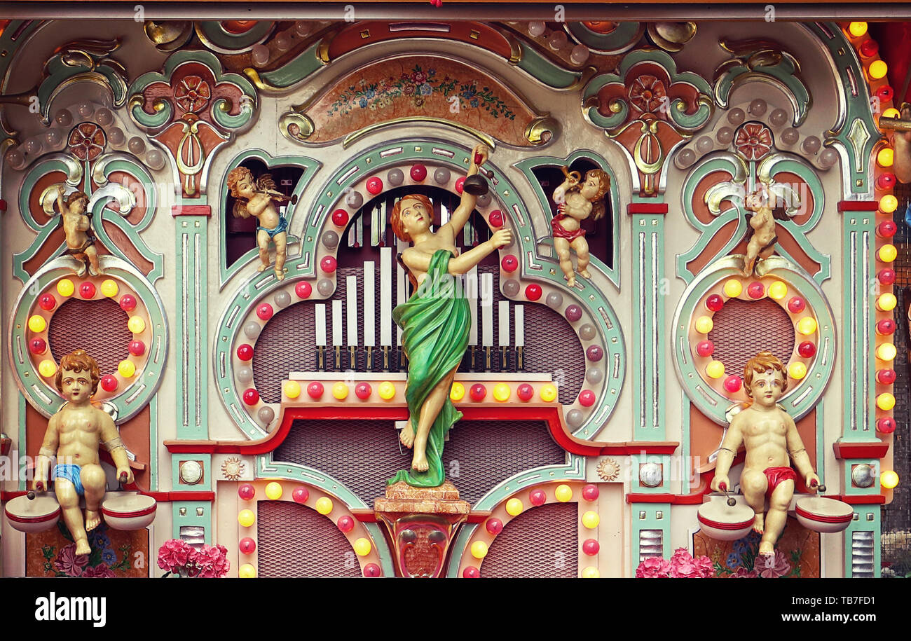 MUNICH, GERMANY - Vintage fairground pipe organ with mechanical figures of puttos and angels and colorful lamps performing at the Auer Dult fair Stock Photo