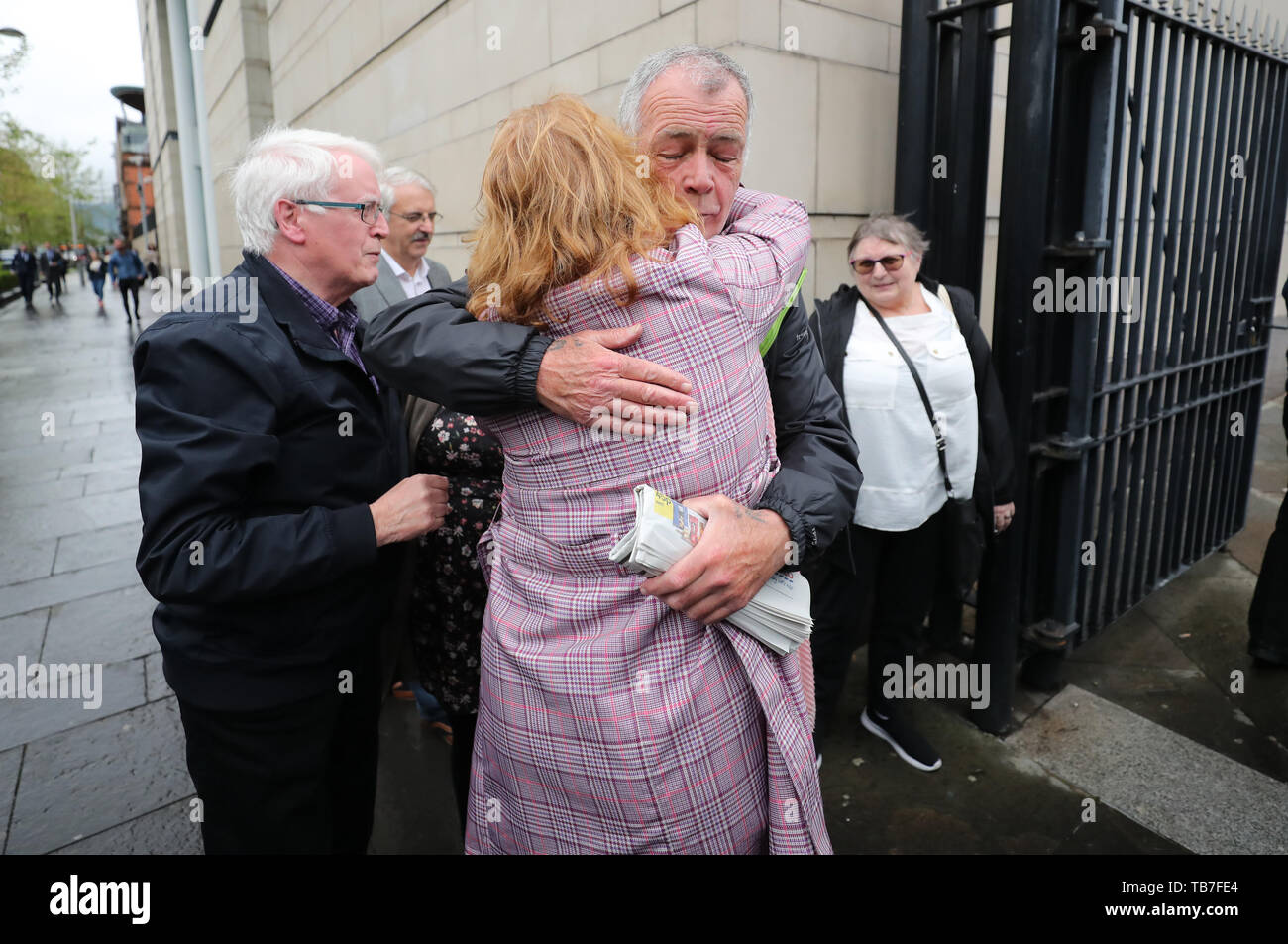 Relatives of those who died on Bloody Sunday in Londonderry and in Ballymurphy embrace each other as they enter Belfast's Laganside courts where General Sir Mike Jackson is due to give evidence to the inquest examined the deaths of ten people killed in shooting involving the Parachute Regiment in Ballymurphy, west Belfast in 1971. Stock Photo