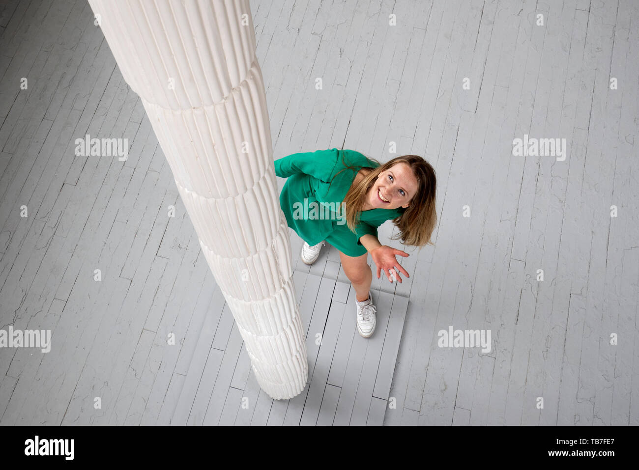 Sculpture student Robyn Seabright takes a closer look at her installation titled Consumption at the media preview of the Edinburgh College of Art degree show in Edinburgh. Stock Photo