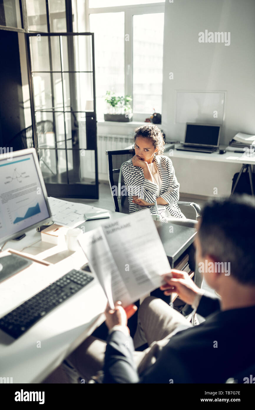 Young woman feeling uncomfortable during job interview Stock Photo