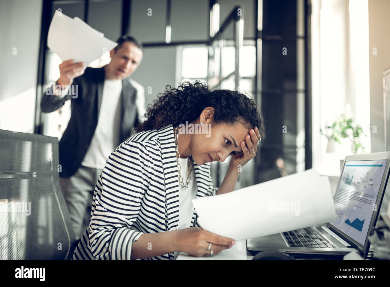 Dark-eyed employee feeling guilty for not completing the task Stock Photo