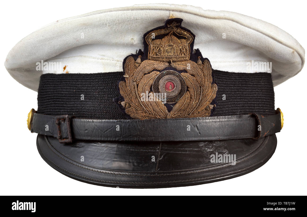 A visor cap for submarine commanders, Fine navy-blue cloth with removable top of white linen, black mohair cap band with cap insignia embroidered in gold, visor lacquered in black with additional edge trim, black patent leather chinstrap on gilt anchor buttons with imperial crown. Lining made of white silk and oil cloth, respectively, sweatband of black replacement material (traces of wear) with white silk strap. Rare visor cap, only submarine commanders were permitted to wear the white-top version. navy, naval forces, military, militaria, branch, Additional-Rights-Clearance-Info-Not-Available Stock Photo