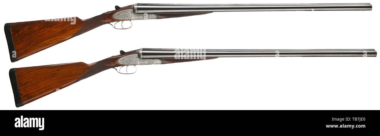 A pair of Holland & Holland side-by-side shotguns, in their case, Cal. 12/70, numbers 16049 and 16050. British proof mark and later German proof mark. Weapons on barrel and operating lever marked '1' (no. 16049) and '2' (no. 16050). Barrel length 76 cm each. Both circa 1/4-choke and cylinder bore. Barrels finished black. Manufacturer's data on barrel rib. Action with double barrel hook locking. Side locks. Double trigger. Safety slide on stock wrist. Action case in silver and shiny metallic, with vine engraving. Blued axles. Action case marked 'H, Additional-Rights-Clearance-Info-Not-Available Stock Photo