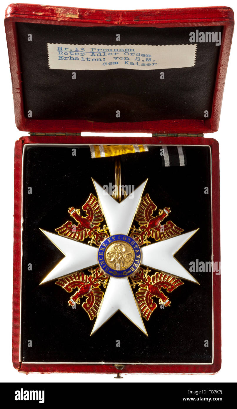 Prince Alfons of Bavaria - Prussia - the Order of the Red Eagle, Fourth version with a brick-red eagle, 1854 - 1918, the badge of the Grand Cross, dimensions 82 x 82 mm, in gold, some parts in a fine guilloche pattern, engraved and chased, enamelled, weight 57 g (including the ring), intact, three barely visible hairline cracks. In outstanding condition. In the red, gold-embossed presentation case, lined in black, with two neck ribbons. A typewritten label in the lid reads: 'Nr. 13 Preussen - Roter Adler Orden - Erhalten: von S.M. dem Kaiser' (tr, Additional-Rights-Clearance-Info-Not-Available Stock Photo