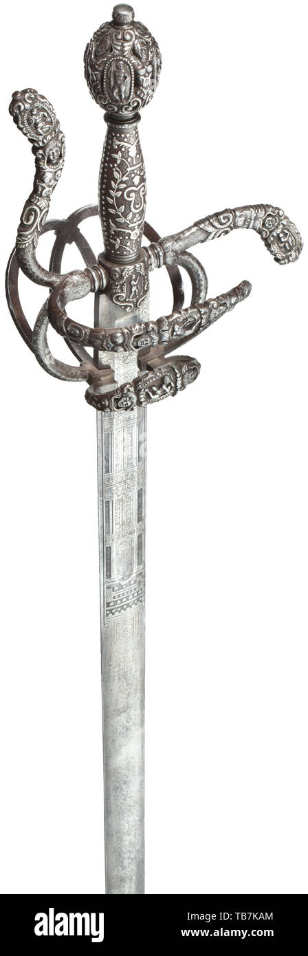 A fine, silver inlaid rapier in the style of circa 1560, Toledo, dated 1878, Double-edged, straight blade with short fuller. On both sides of the forte floral etchings with Latin inscriptions and remains of gilding. Iron swept hilt, decorated with deeply chiselled figures and flowers and silver inlays. The reverse of the bars with silver quatrefoil dot inlays. Screw-mounted pommel with elaborate silver inlays and chiselled openwork figures. The iron grip on matted base with silver inlays of flowers and dots. The tang stamped 'TOLEDO 1878'. Length, Additional-Rights-Clearance-Info-Not-Available Stock Photo