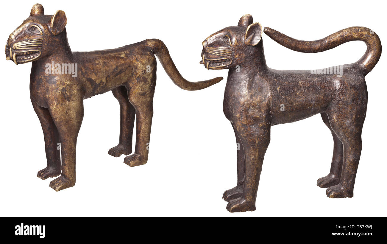 A pair of Nigerian bronze leopards, Benin, 1st half of the 20th century, Bronze cast with dark patina, slightly rubbed in places, with finely engraved surface. Depiction of a male and a female animal in typical posture. Height 59 cm and 61 cm, length 60 cm and 93 cm. Included is a thermoluminescence expertise dated 2002 which narrows the age of the sculptures to 80 years (+/- 25 years). The leopard was the symbol of the ruler, and the stories built around it were closely intertwined with the royal myths. Leopards were kept as domestic animals at , Additional-Rights-Clearance-Info-Not-Available Stock Photo