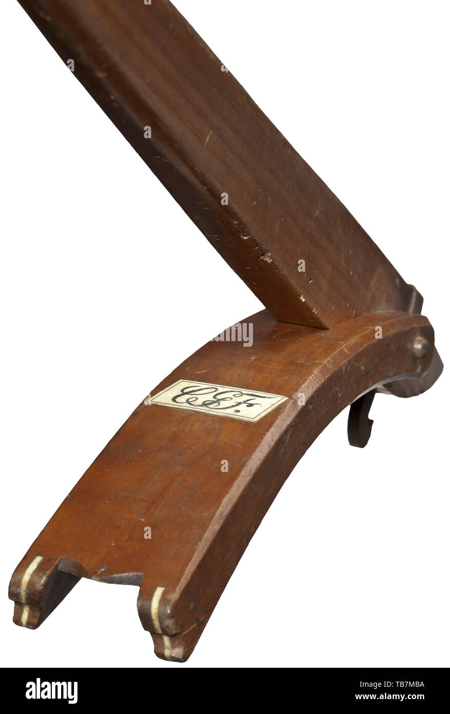 A Saxon sport crossbow with gaffle, circa 1830, Heavy iron prod with a later hemp string and original decorative woollen tassels. The inside of the bow embellished with floral ornaments. The original bridle of cord with tassels made of wool pompoms. The walnut tiller with quarrel groove and overlay of bone. Iron nut with brass bolt clip. Set trigger, iron finger rests. On the cheek an inlaid compass rose made from black horn and bone. Also, the corresponding wooden gaffle inlaid with a monogram plaque 'SGF' in bone. Length 80 cm. A typically heav, Additional-Rights-Clearance-Info-Not-Available Stock Photo