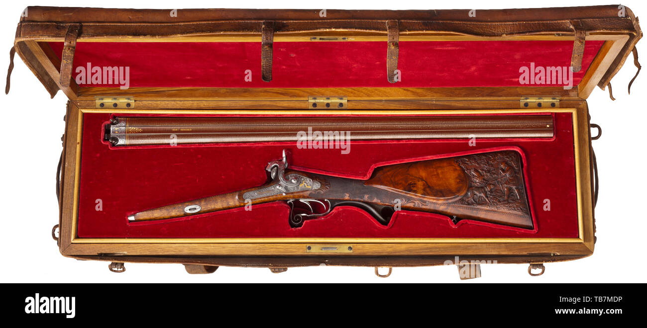 A deluxe percussion double-barrelled shotgun, G. and F. Spicker, circa 1850, The browned Damascus barrels in 17.5 mm calibre, the bores slightly rough. The patent breechblock and tang engraved with decorative tendrils and gold-inlaid animals. The barrel rib stamped 'DAM:BERNARD.' En suite decorated percussion locks with chiselled hunting scenes of game and 19th century, Additional-Rights-Clearance-Info-Not-Available Stock Photo