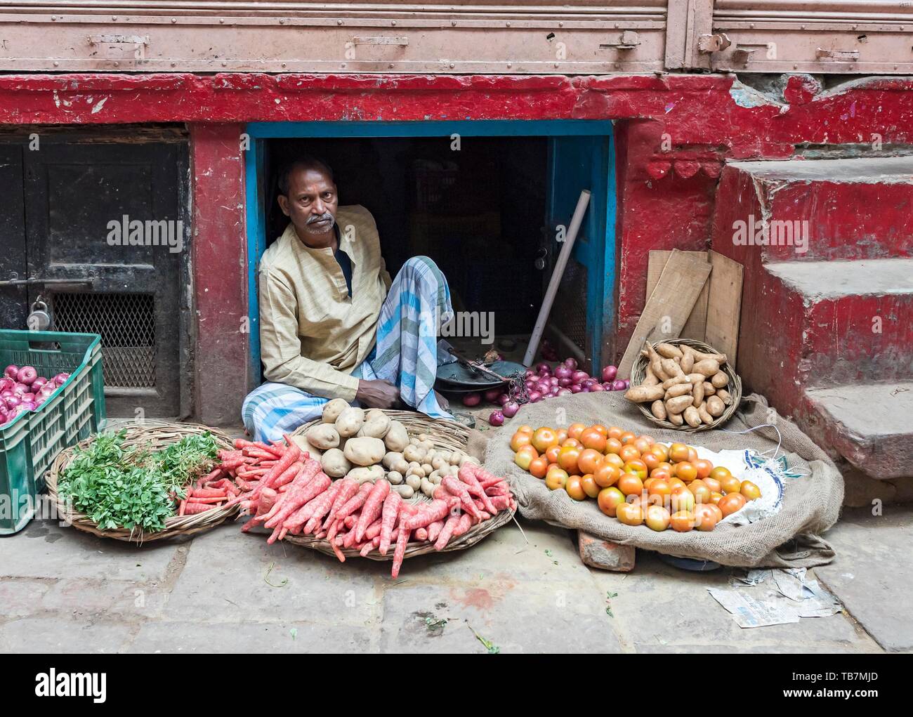 Man selling vegetables in the street market, Old City of Varanasi, Uttar Pradesh, India Stock Photo