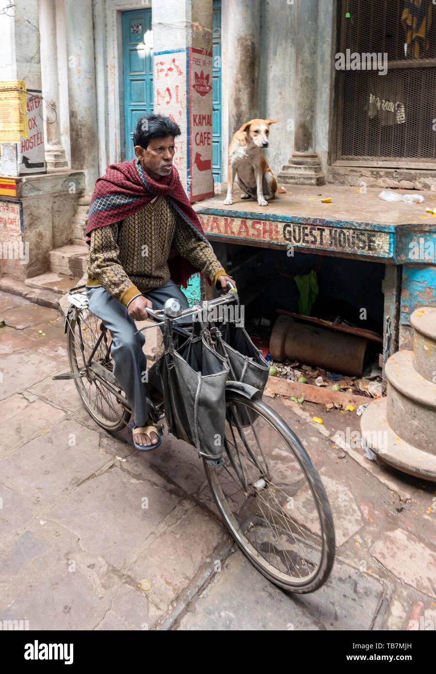 Man on bicycle in narrow streets, Old City of Varanasi, Uttar Pradesh, India Stock Photo