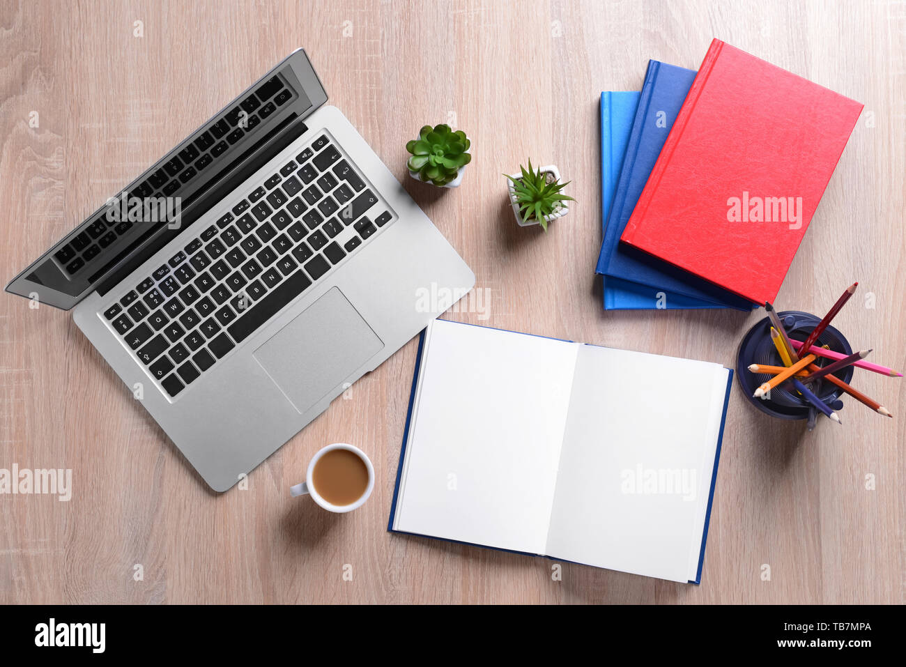 Books and laptop on wooden table Stock Photo Alamy