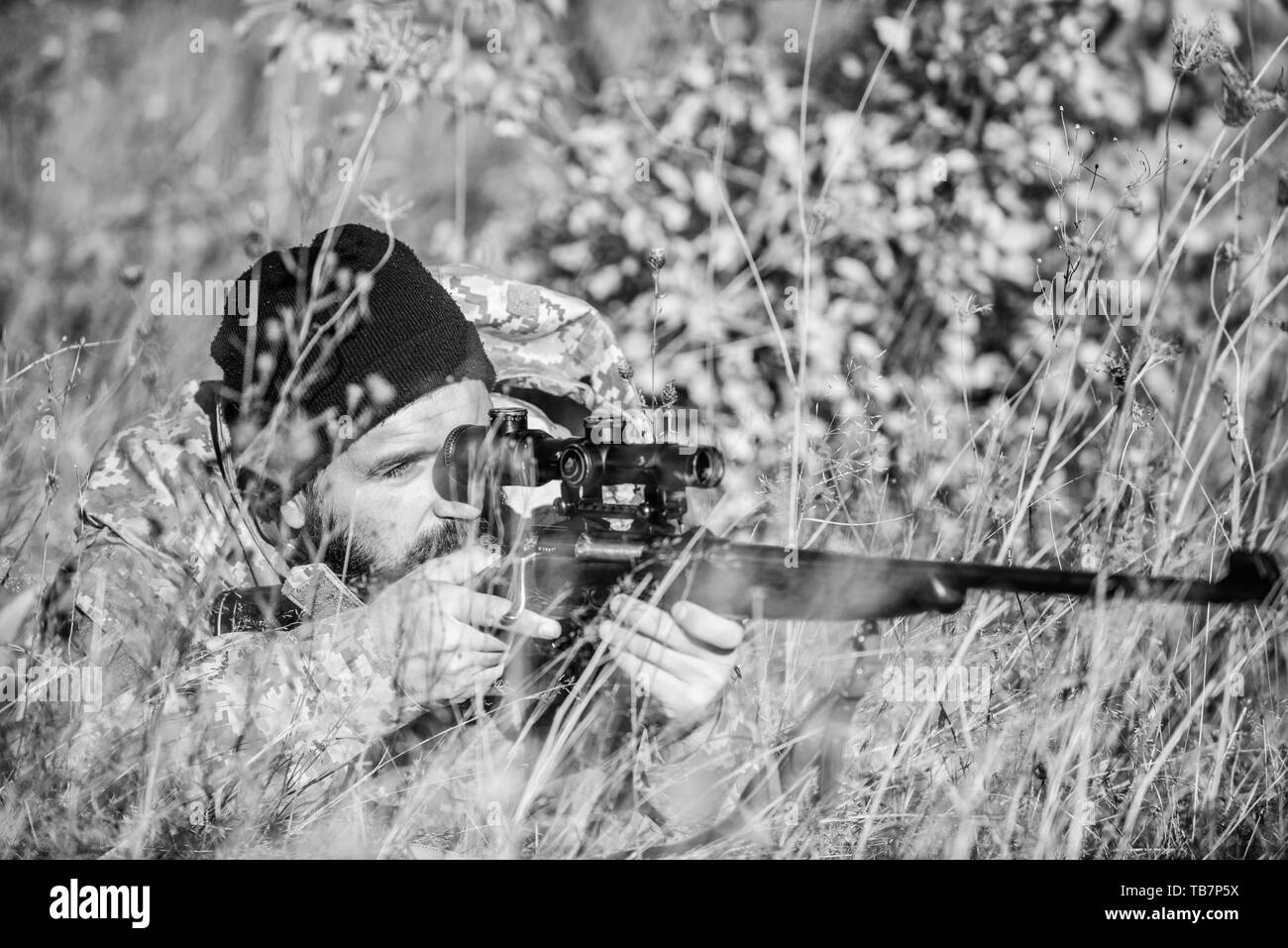 Bearded man hunter. Military uniform fashion. Army forces. Camouflage. Hunting skills and weapon equipment. How turn hunting into hobby. Man hunter with rifle gun. Boot camp. Military action Stock Photo