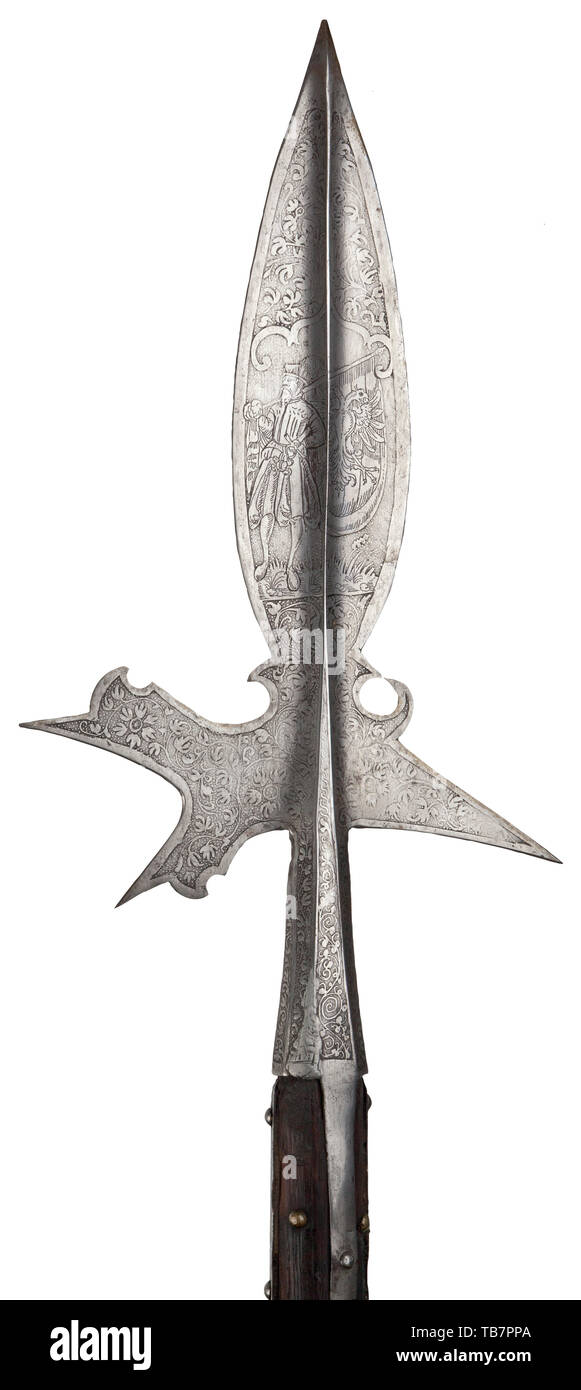 An etched Austrian halberd, circa 1580/90, Wide, leaf-shaped spike with distinctive central ridge on both side. Slender, jagged blade with robust rear fluke. Octagonal socket with four side straps (repair at the lower edge). Profuse etchings on both sides. On one side the portrayal of a Landsknecht ensign with a Reich eagle flag, on the other side the coat of arms of Burgundy-Habsburg consisting of an angular cross and fire strikers. The remaining surfaces decorated with fine flowers and scrolling leaves. Original staff of studded hard wood. The , Additional-Rights-Clearance-Info-Not-Available Stock Photo