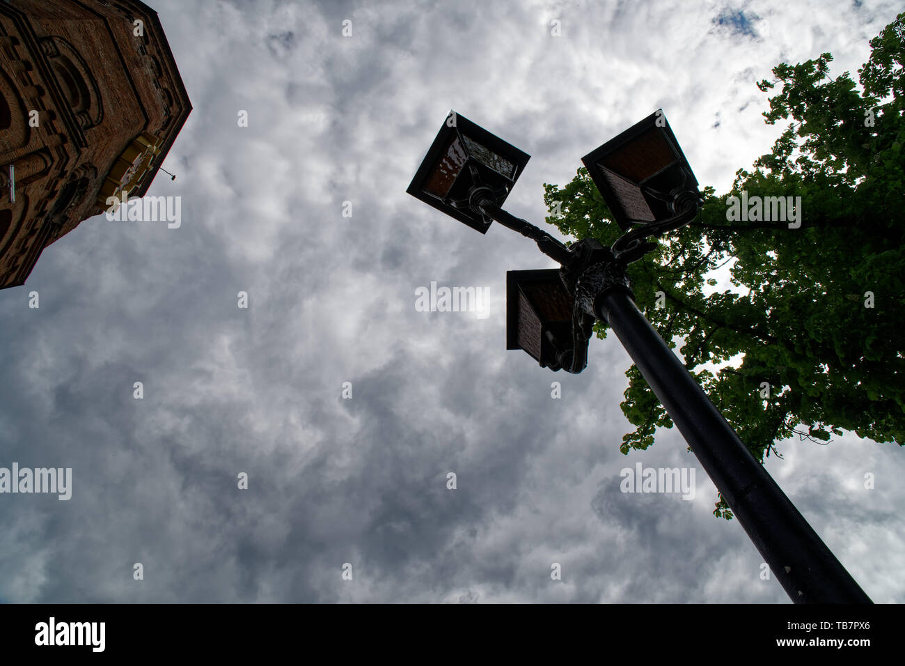 Old style street light against the overcast sky. City vintage lantern City street eastern european country Ancient places. Stock Photo