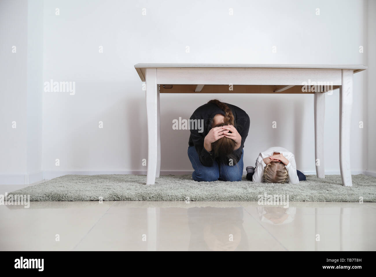 Woman under table hiding hires stock photography and images Alamy