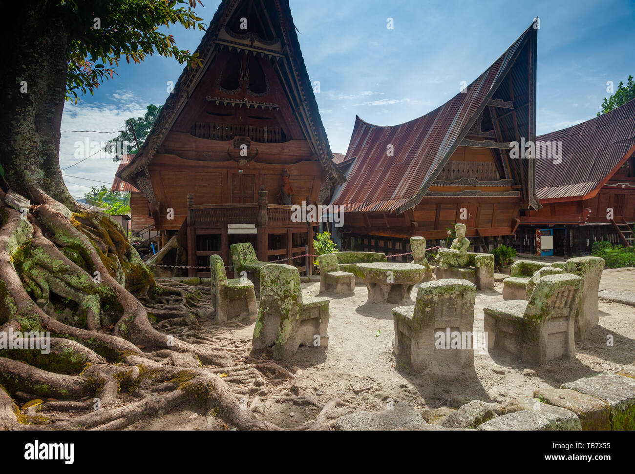 Stone chairs of Ambarita and traditional Batak roof houses, Samosir Island, Lake Toba Stock Photo