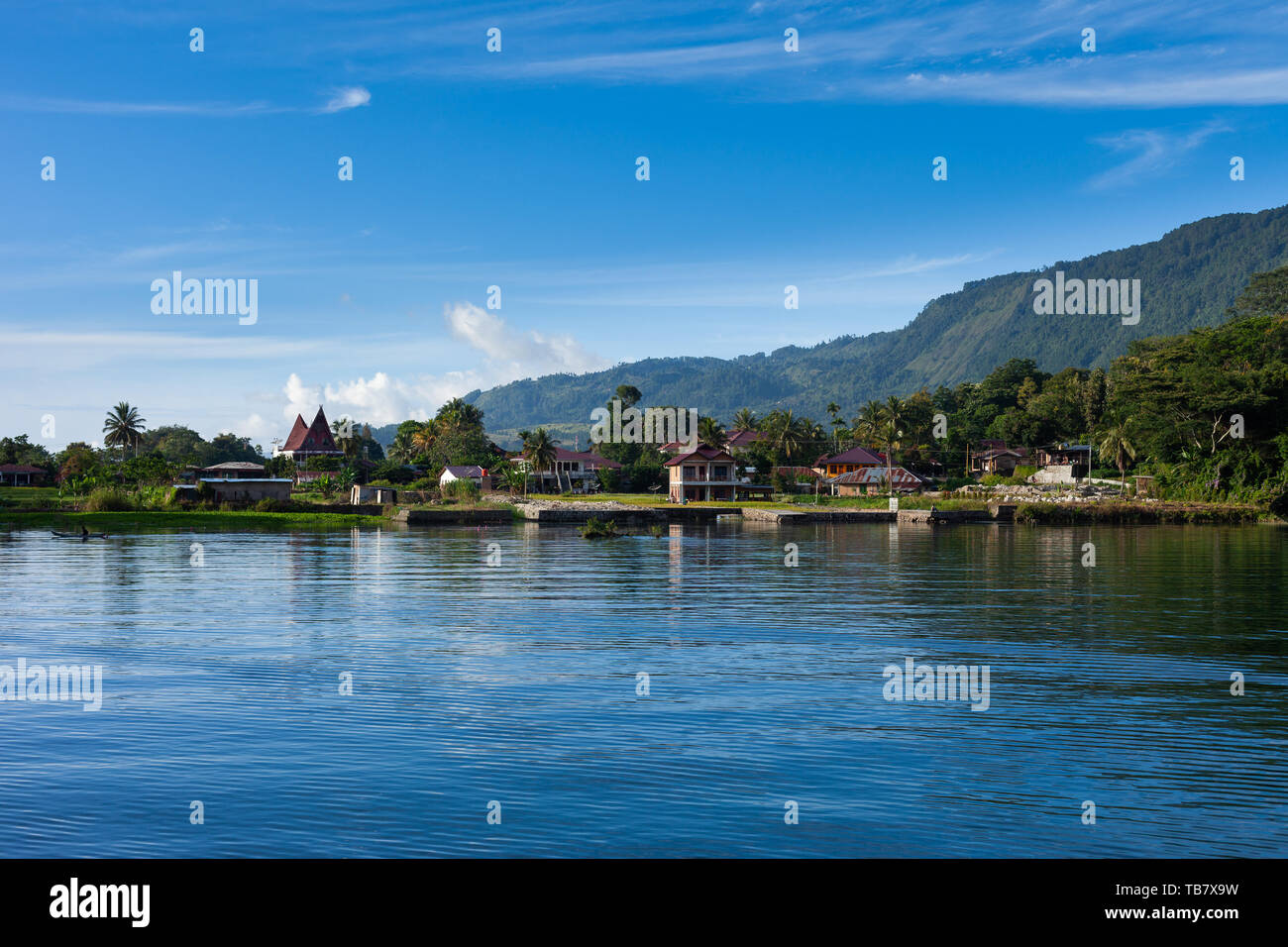 Houses and hotels on Lake Toba at Tuk Tuk peninsula, Samosir Island, Sumatra, Indonesia Stock Photo