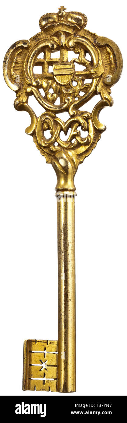 A historic chamberlain's key, bearing the cypher of Maximilian Franz of Austria, Archbishop of Cologne and Prince Elector of Hapsburg-Lorraine, together with the arms of the Teutonic Order, of which he was Grand Master, circa 1784 - 1801, Of gilt bronze, cast in low relief, the top formed as a rococo cartouche surmounted by an archducal crown, pierced with the quartered arms of the Archduke Maximilian Franz, the in-escutcheon charged with the 'bindenschild' on one side and with the arms of the Teutonic Order on the reverse, and with the cypher of, Additional-Rights-Clearance-Info-Not-Available Stock Photo