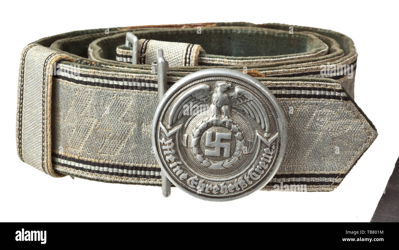 A parade waist belt for leaders of the Waffen SS, Aluminium fabric interwoven with SS runes, a green velvet cloth on the reverse, the leather tongue with manufacturer's mark and size stamp '100'. The aluminium buckle with the manufacturer's mark of Overhoff & Cie. 'RZM SS OLC 36/39' on the back. Worn condition. historic, historical 20th century, Editorial-Use-Only Stock Photo